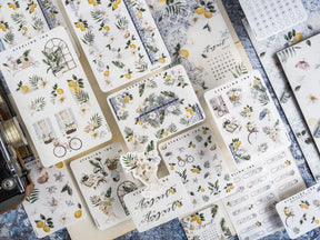 "August" script sticker featuring a rustic floral wreath and cluster of botanical elements, perfect for seasonal journaling.