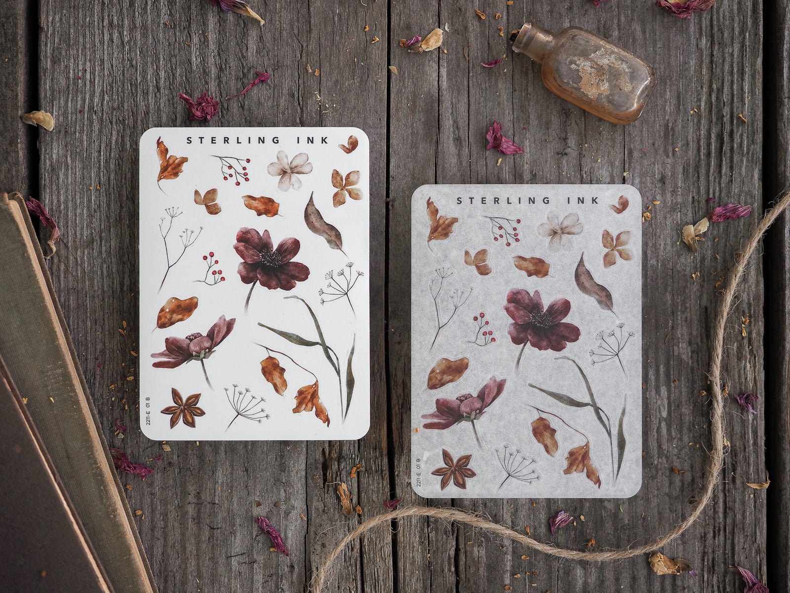 Two decorative stickers featuring detailed autumnal botanical elements, including brown leaves, small white flowers, and delicate plant arrangements on a white background.