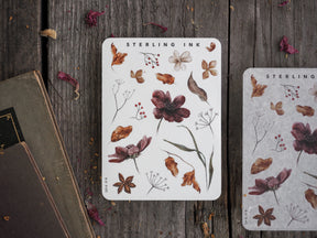 Autumnal botanical elements sticker sheet featuring detailed illustrations of dried flowers, leaves, and natural motifs in rustic brown and deep burgundy tones.